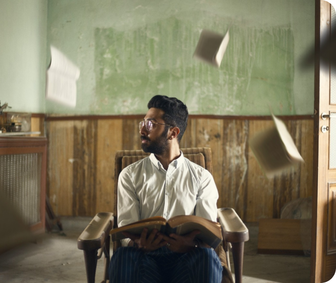Professional in a chair with papers flying
